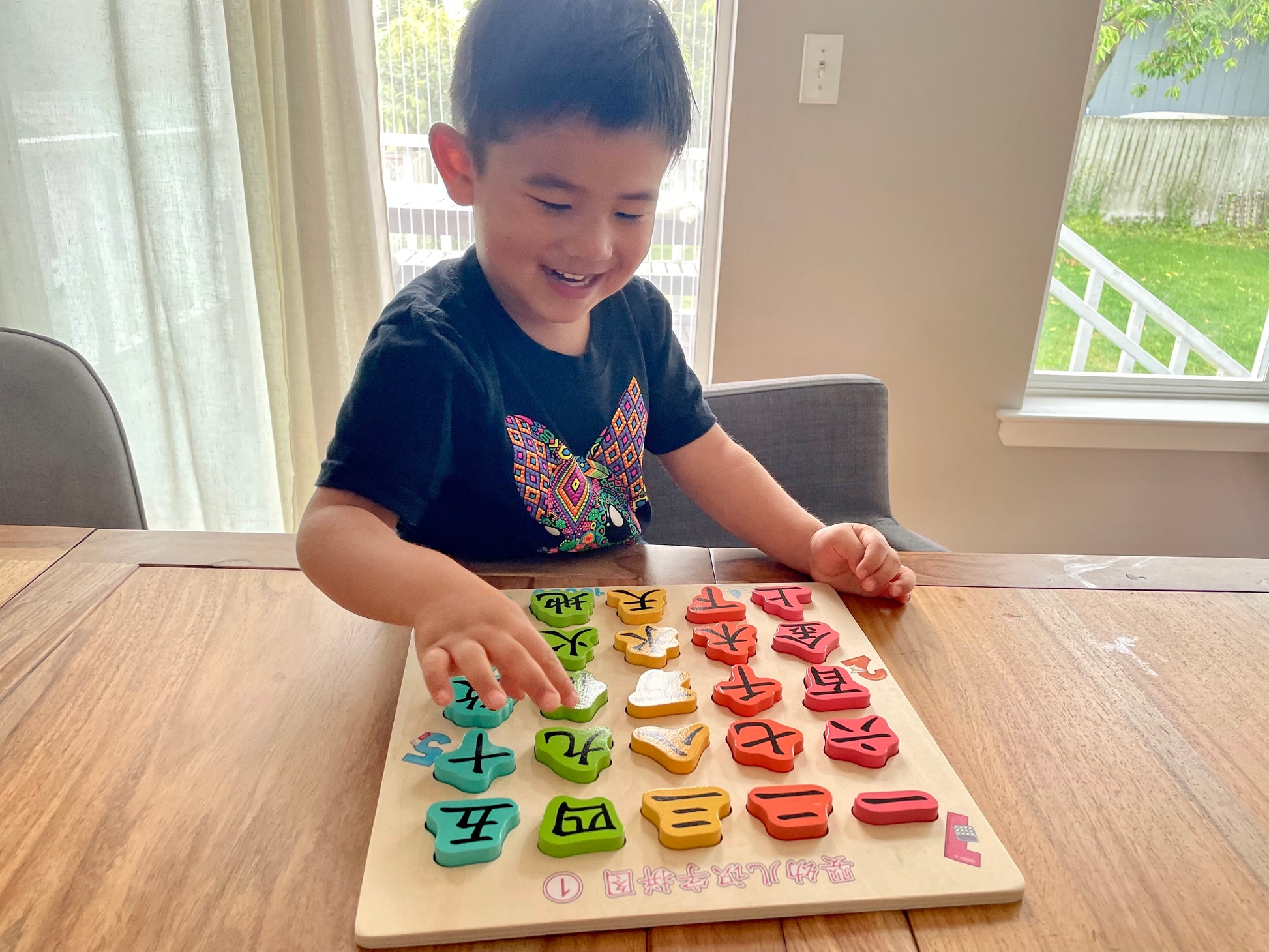 Image of kid playing with First Chinese Characters Wooden Puzzle Set